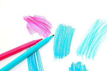Two felt-tip pens on a white background with abstract drawings
