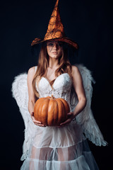Halloween people in angel costume. Happy Halloween Angelic Witch. Halloween Party girl. Beauty...