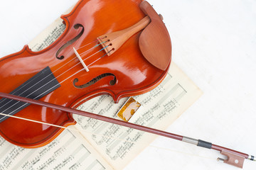 Fototapeta premium Part of the violin, bow and rosin isolated on a white background.