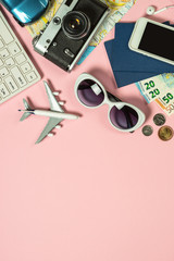 Summer travel concept on pink background top view.