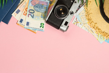 Summer travel concept on pink background top view.