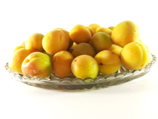 Ripe apricots on plate, white background. Isolated fruits photo