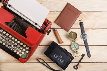 Writer or journalist workplace - vintage red typewriter on the wooden desk