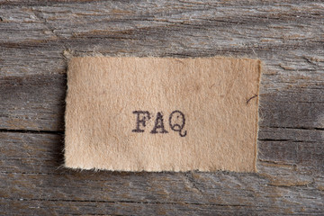 FAQ word on a piece of paper close up, business creative motivation concept