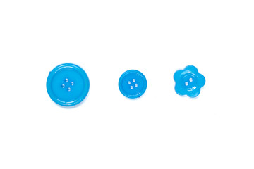 Three Various blue sewing buttons isolated on background