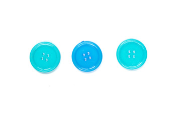 Three Various blue sewing buttons isolated on background