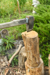 The process of cutting wood with a cleaver. Axe in the log