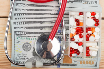 Doctors medical stethoscope on money background healthcare expensive concept