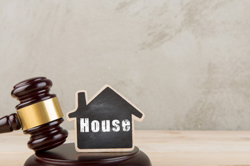 Real estate concept auction gavel and little house with inscription House