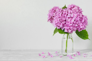 Still life with a beautiful pink hydrangea flowers on white wooden table with copy space. wedding...
