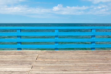Fototapeta na wymiar bright wooden pier by the sea on a sunny summer day