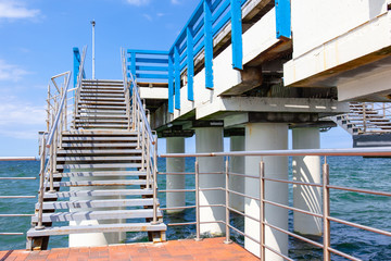 large pier with stairs by the sea on a sunny summer day