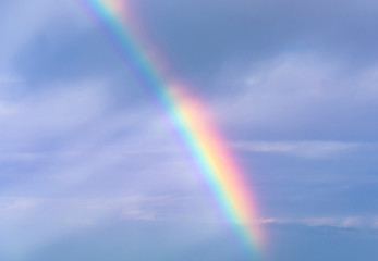 Real Rainbow and Sky with Clouds as Background or Texture