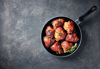 grilled chicken thighs in a frying pan