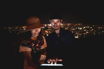 using tablet over the mountain city view at night