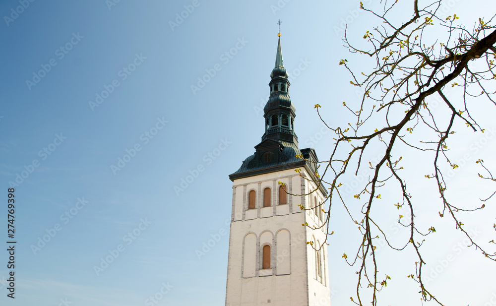 Wall mural old tower of church on blue sky background