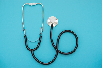 Stethoscope on blue background. Health care concept.