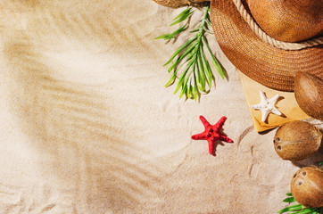 Summer background with copy space. Top view of sandy beach with visible sand texture and exotic accessories. Backdrop for products and mockup.
