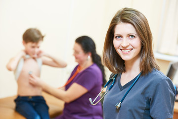female children's doctor in front of pediatrician little boy examination