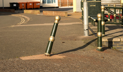Phallic shaped metal bollard leaning over