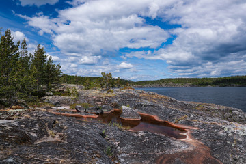 Rocky islet with trees on Lake Ladoga