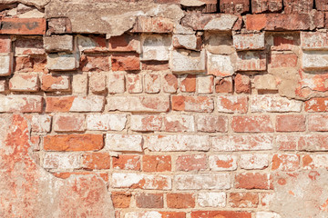 abstract background of an old brick wall with peeling plaster close up