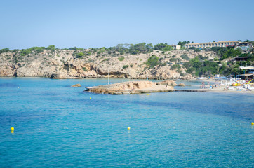 Fototapeta premium View of Cala Tarida with rocks in turquoise sea water, Ibiza island, Spain