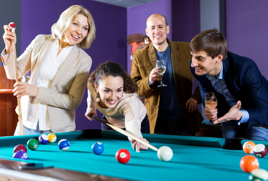 Group of friends playing billiards