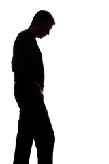 Portrait of a young man, side view - dark isolated silhouette