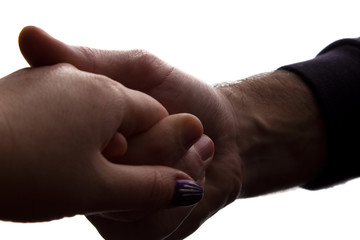 Fototapeta premium Man gently holding his beloved by the hand - silhouette love