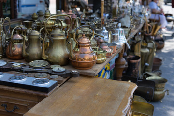 Antique antiques are sold at a flea market.Coffee turks and copper kettles.
