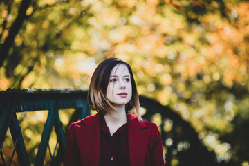 woman in red coat have a rest in autum park