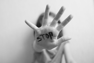 Little girl protects herself with a hand on the palm of her inscription 
