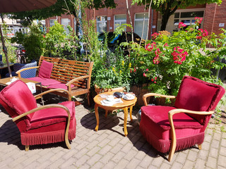 Cosy red upholstered seats in a street cafe in Cologne