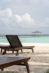Fototapeta na wymiar Beautiful beach with chaise lounge with ocean landscape