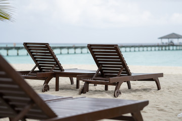 Fototapeta na wymiar Beautiful beach with chaise lounge with ocean landscape