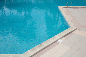 corner swimming pool detail with clear blue water