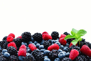 Blackberry, raspberry, blueberry and mint background.