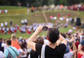 Woman taking photo of live stage performance