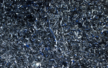 Steel scrap materials recycling. Abstract, background and texture of metal shavings. Aluminum chip waste after machining metal parts on a cnc lathe - obrazy, fototapety, plakaty