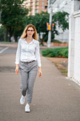 young beautiful woman walk on street spend time on fresh air