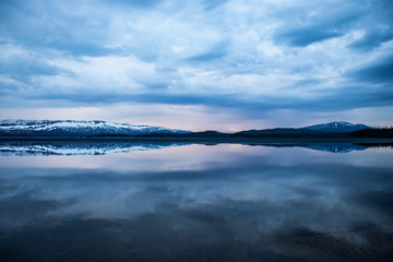 Majavatn in the north of Norway tranquil water with reflection of mountains