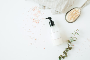 Healthcare spa concept with copy space liquid soap bottle, eucalyptus, hairbrush on white background. Flat lay, top view beauty lifestyle composition. - obrazy, fototapety, plakaty