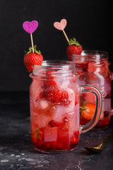 Strawberry lemonade with ice in jar