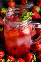 Close up strawberry lemonade with ice in jar
