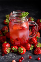 Fototapeta na wymiar Cold drink with strawberries and ice