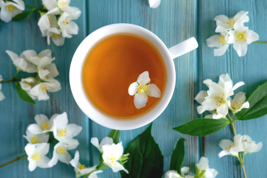 Jasmine tea on a blue wooden background. Relaxing jasmine tea. Aromatic teas for relaxation and health
