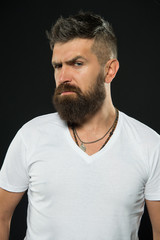 Obraz premium Hipster masculinity. Brutal hipster on black background. Caucasian hipster with thick beard hair and stylish haircut. Bearded man in trendy hipster style