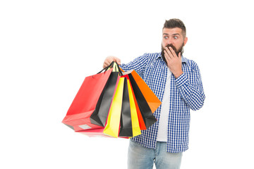 I survived Black Friday. Surprised hipster holding shopping bags after Black Friday isolated on white. Bearded man opening his shopping season on Black Friday. Offering deep discounts on Black Friday