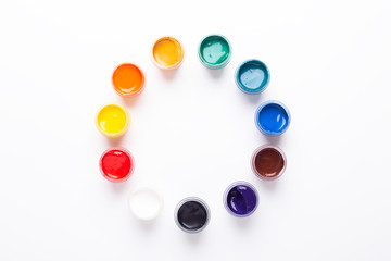 Multicolored gouache on a white background Circle shape Isolated Paints in containers Top view